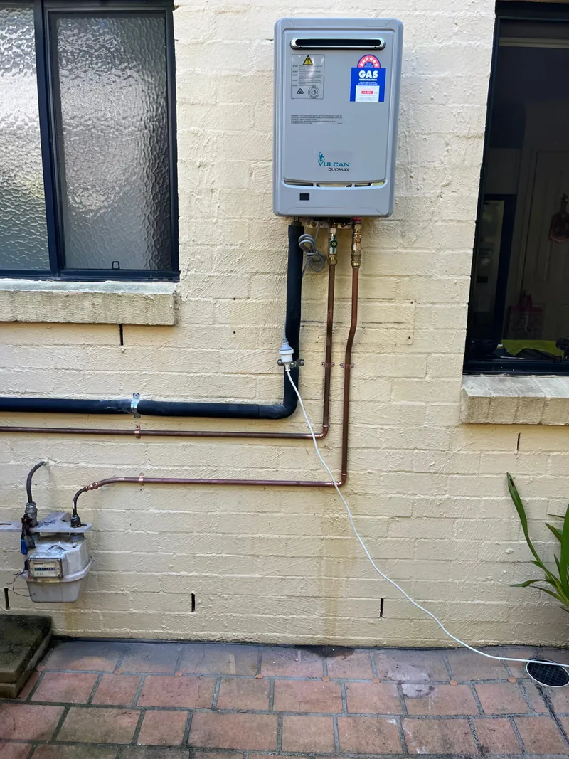 Rinnai continuous flow gas hot water unit installed on an external wall with new copper gas and water lines